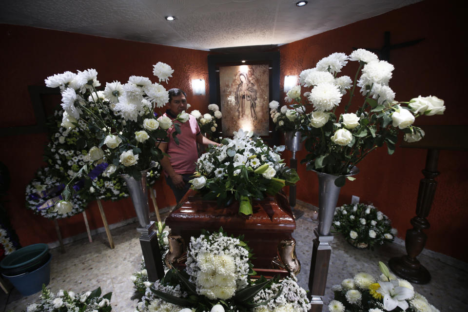 Funeral flowers surround the casket containing the remains of 37-year-old Liliana Lopez who died in the Mexico City Metro collapse disaster, during a wake in Mexico City, Wednesday, May 5, 2021. Monday night’s accident was one of the deadliest in the history of the capital's subway system. (AP Photo/Marco Ugarte)