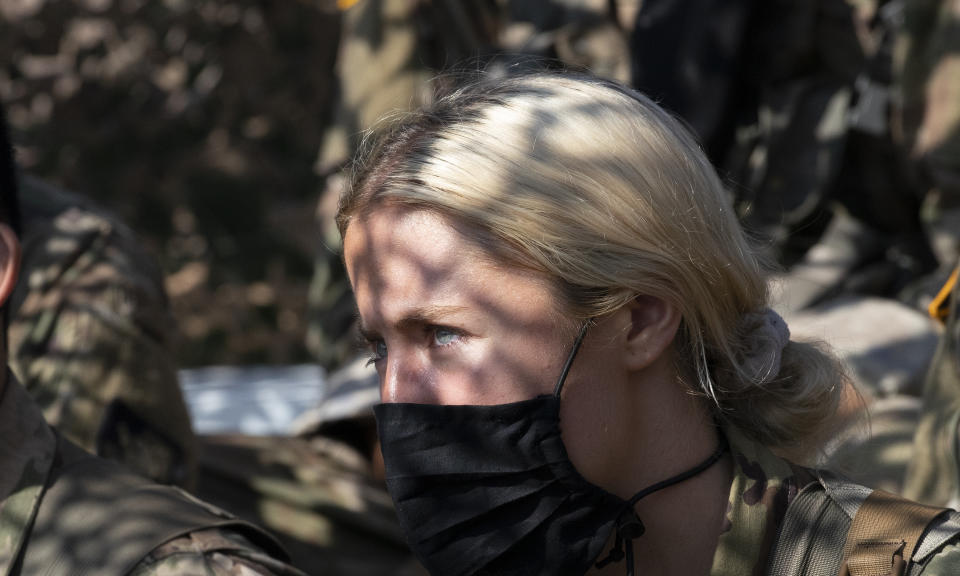 Madison Warne, of Valhalla, N.Y, listens to instructions at a mortar range, Friday, Aug. 7, 2020, at the U.S. Military Academy in West Point, N.Y. The pandemic is not stopping summer training at West Point. Cadets had to wear masks this year for much of the training as the future U.S. Army officers learned military skills. (AP Photo/Mark Lennihan)