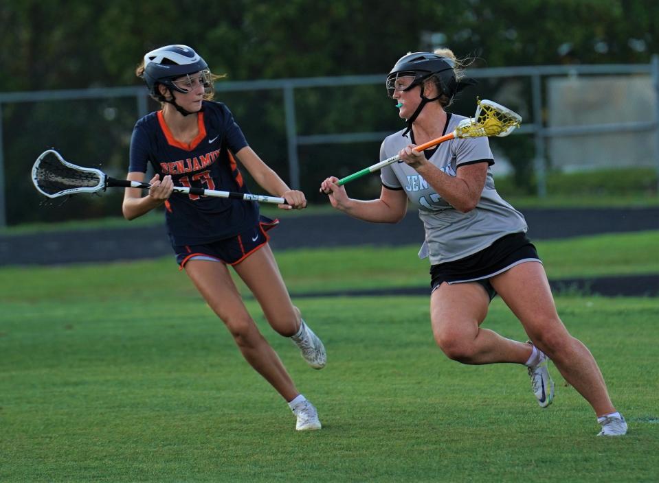 Jensen Beach's Julia Kerr is defended by Benjamin's Pryce Savidge during the District 13-1A girls lacrosse championship game on Friday, April 14, 2023 in Jensen Beach. Benjamin won 7-6.