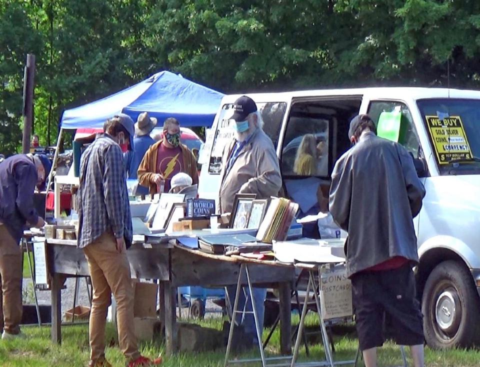 A customer looks over a vendor's wares at Rietta Flea Market in Hubbardston.