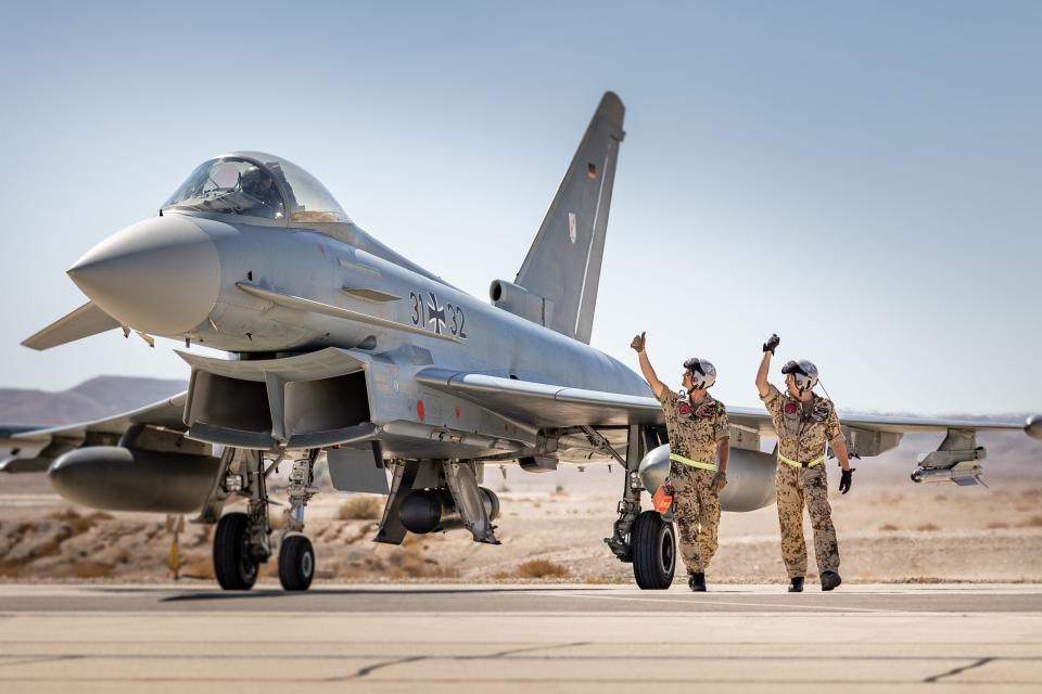 Ground crew signal to the pilot of a Luftwaffe Eurofighter during Exercise Blue Flag 2021 at Ovda Air Base in Israel, in October 2021. <em>Bundeswehr/Falk Bärwald</em>