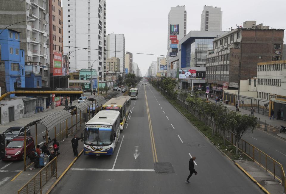 Venezuelan migrant Freddy Brito, who lost a leg when he was shot years ago at a party in Venezuela, hops across Brazil Avenue in Lima, Peru, Tuesday, Oct. 8, 2019. Brito's prosthetic leg attaches to his knee and requires a liner that should be replaced every six months but is now three years old. It cuts into his skin so painfully that he chooses not to wear it, hopping around Lima on one foot instead. (AP Photo/Martin Mejia)