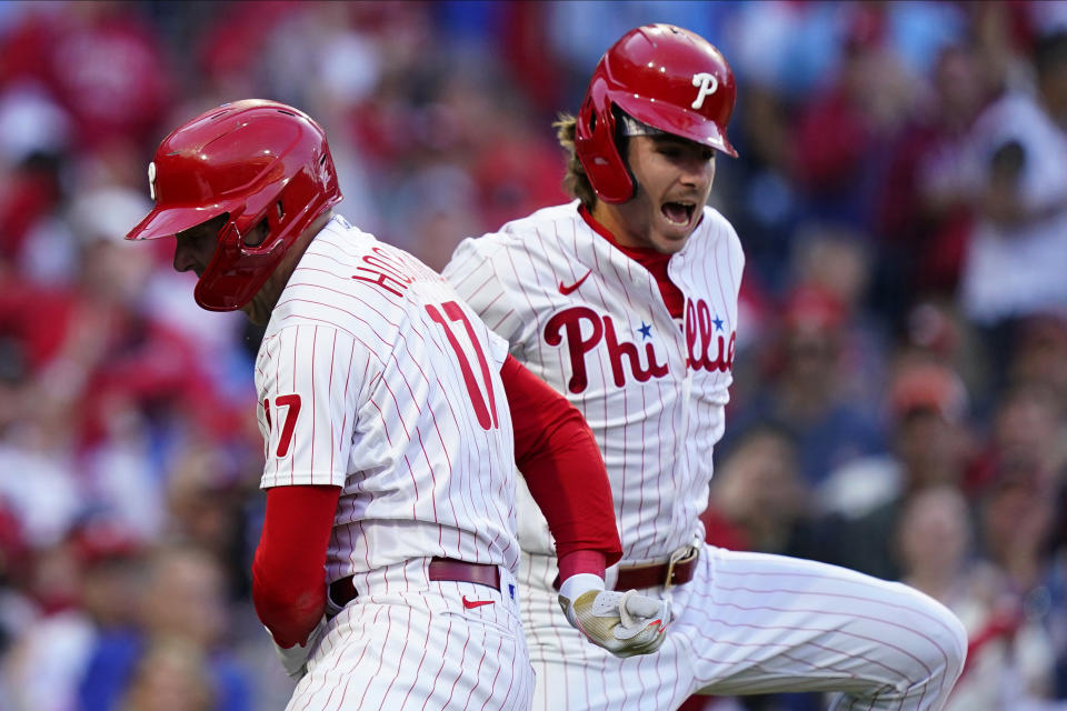 Philadelphia Phillies' Rhys Hoskins (17) celebrates with Bryson Stott (5) after hitting a three-run home run during the third inning in Game 3 of baseball's National League Division Series against the Atlanta Braves, Friday, Oct. 14, 2022, in Philadelphia. (AP Photo/Matt Rourke)