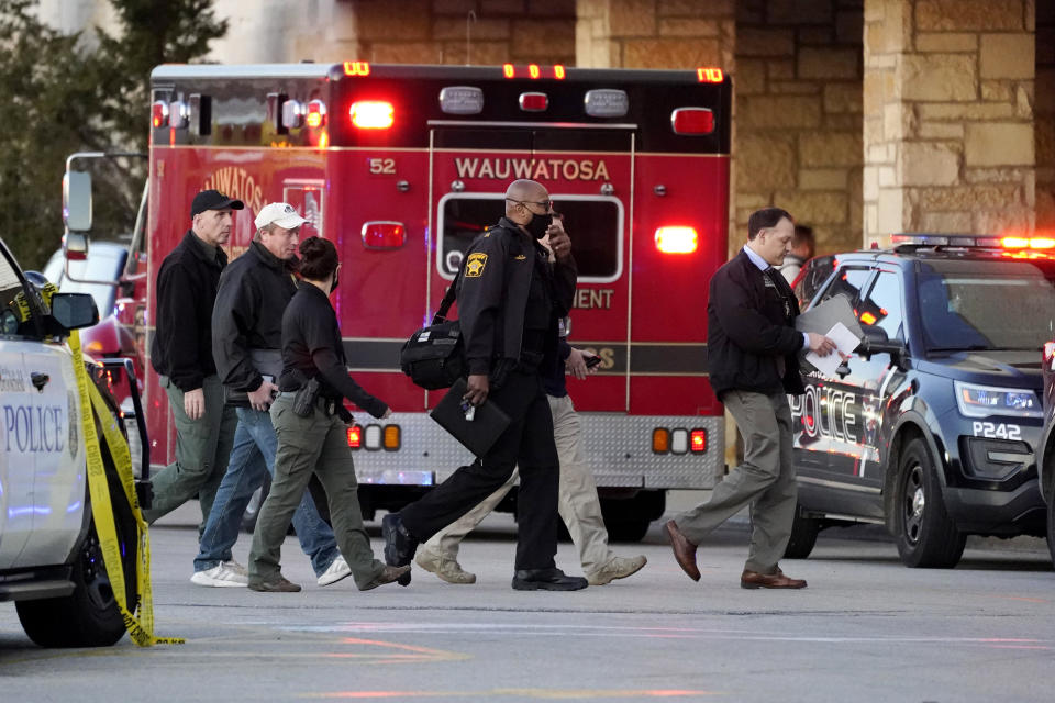 Police officials walk to the Mayfair Mall on November 20, 2020, in Wauwatosa, Wisconsin.  / Credit: Nam Y. Huh / AP