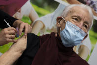 Jos Bieleveldt, 91, receives a COVID-19 vaccine in Apeldoorn, Netherlands, Tuesday, Jan. 26, 2021. Jos Bieleveldt had a spring in his 91-year-old step when he became one of the first Dutch recipients in his age group to get the coronavirus vaccine. One thing though, it really took too long a time coming. The 27-nation EU is coming under criticism for the slow rollout of its vaccination campaign. The bloc, a collection of many of the richest countries in the world, is not faring well in comparison to countries like Israel, the United Kingdom and the United States. (AP Photo/Peter Dejong)