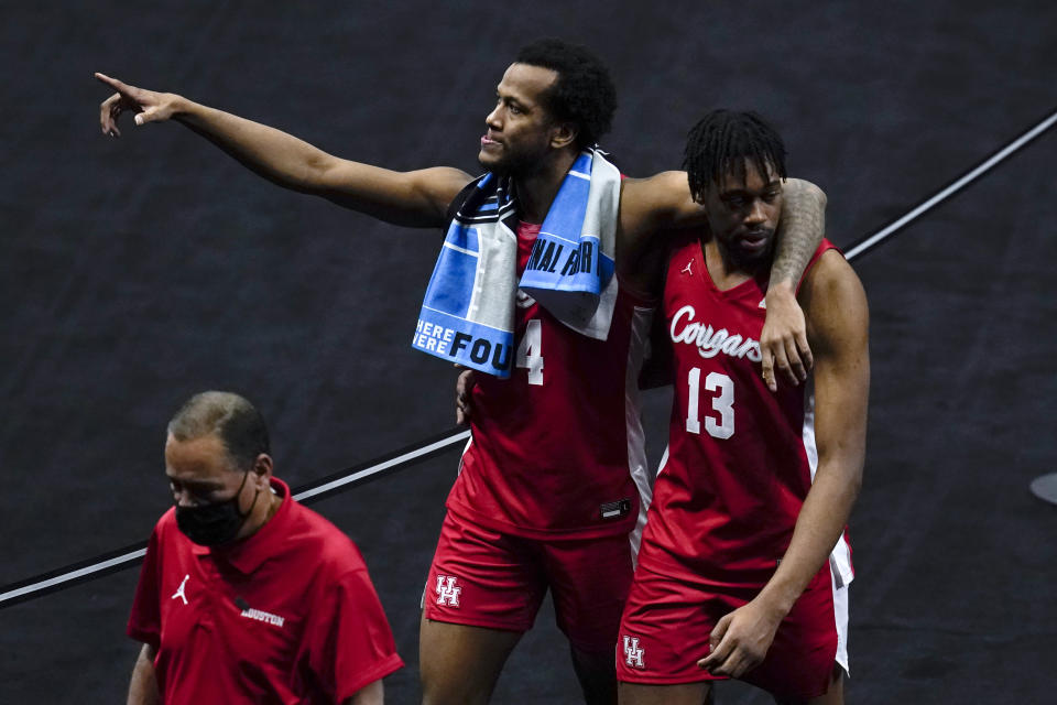 Houston forward Justin Gorham, left, walks off the court with teammate forward J'Wan Roberts (13) at the end of a men's Final Four NCAA college basketball tournament semifinal game against Baylor, Saturday, April 3, 2021, at Lucas Oil Stadium in Indianapolis. Baylor won 78-59. (AP Photo/Michael Conroy)