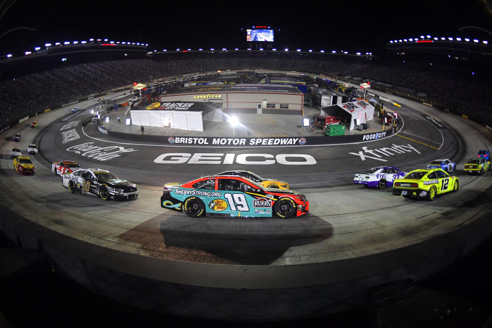 BRISTOL, TENNESSEE - SEPTEMBER 18: Martin Truex Jr., driver of the #19 Bass Pro Shops/SherryStrong.org Toyota, Ryan Blaney, driver of the #12 Menards/Richmond Ford, and Aric Almirola, driver of the #10 Smithfield Ford, race during the NASCAR Cup Series Bass Pro Shops Night Race at Bristol Motor Speedway on September 18, 2021 in Bristol, Tennessee. (Photo by Logan Riely/Getty Images)