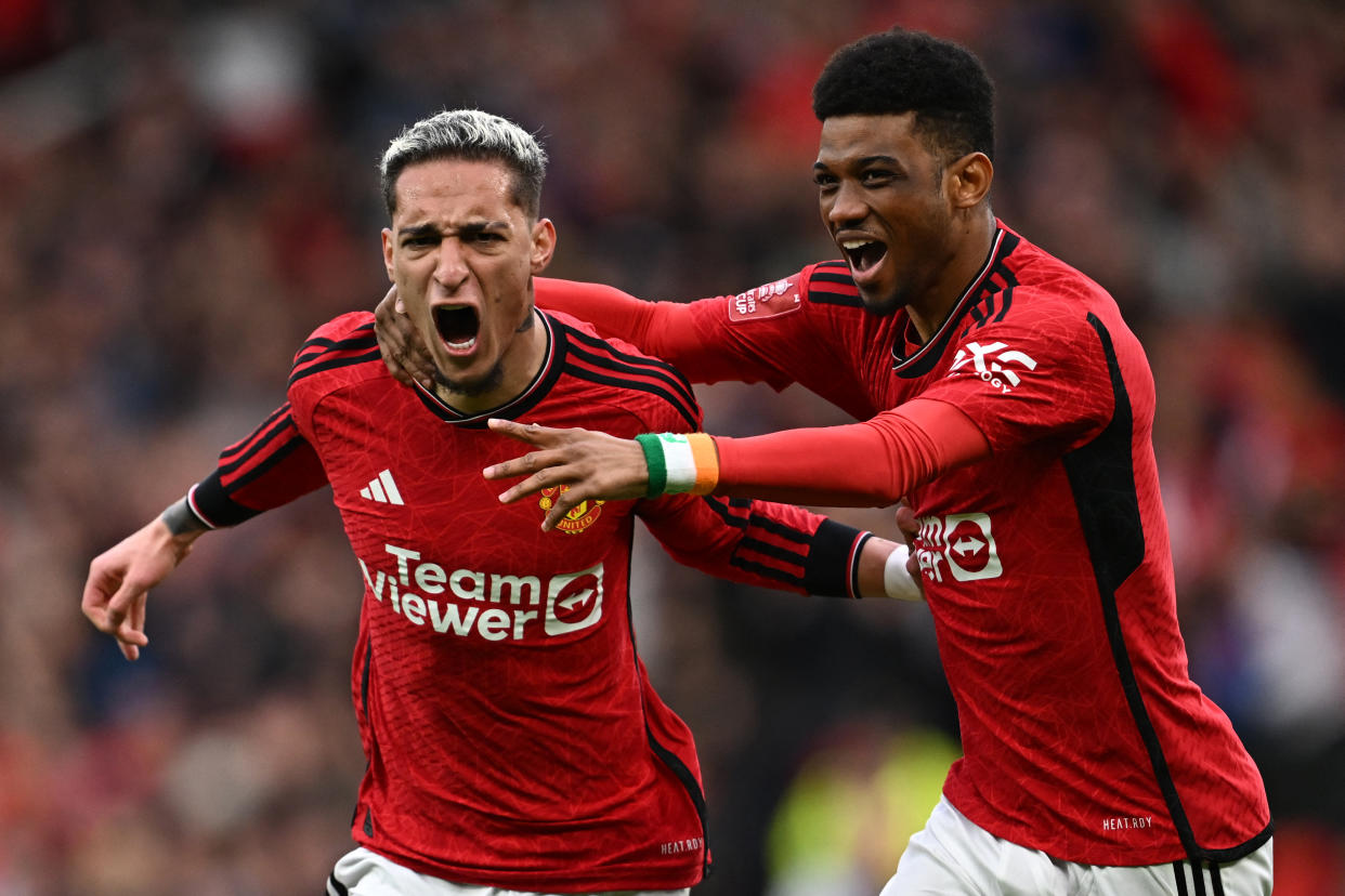 Manchester United midfielder Antony (left) celebrates with teammate Amad Diallo after scoring their second goal during the FA Cup quarter-final football clash with Liverpool at Old Trafford.