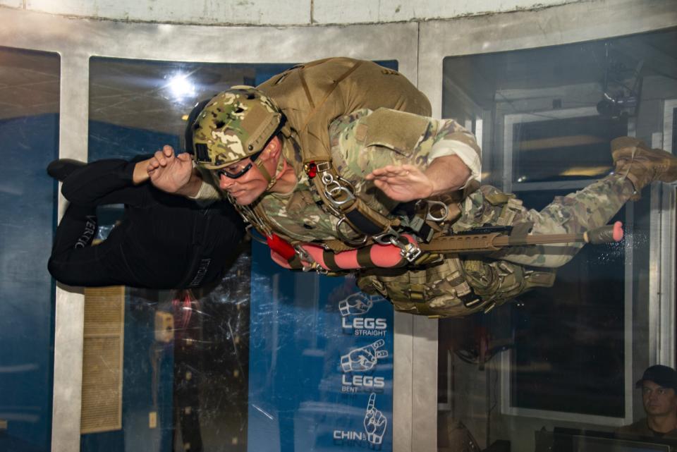 A Special Operations Sniper participating in the MK-22 Precision Sniper Rifle (PSR) test conducts vertical wind tunnel testing with his MK-22 in the “front-mount” configuration