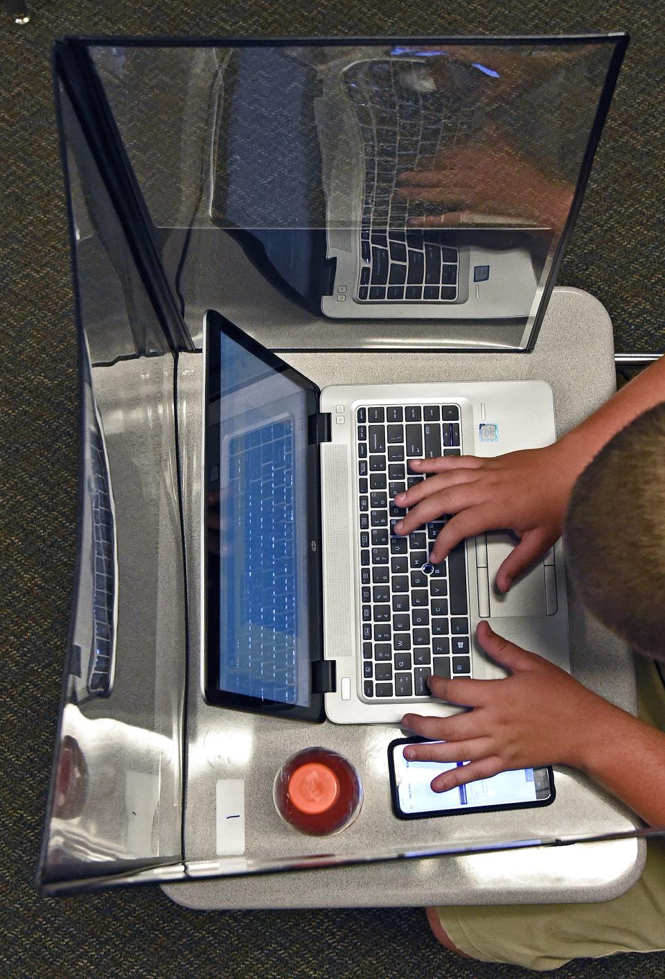 A student works on a laptop during a recent school day at Booker High School in Sarasota, Fla..