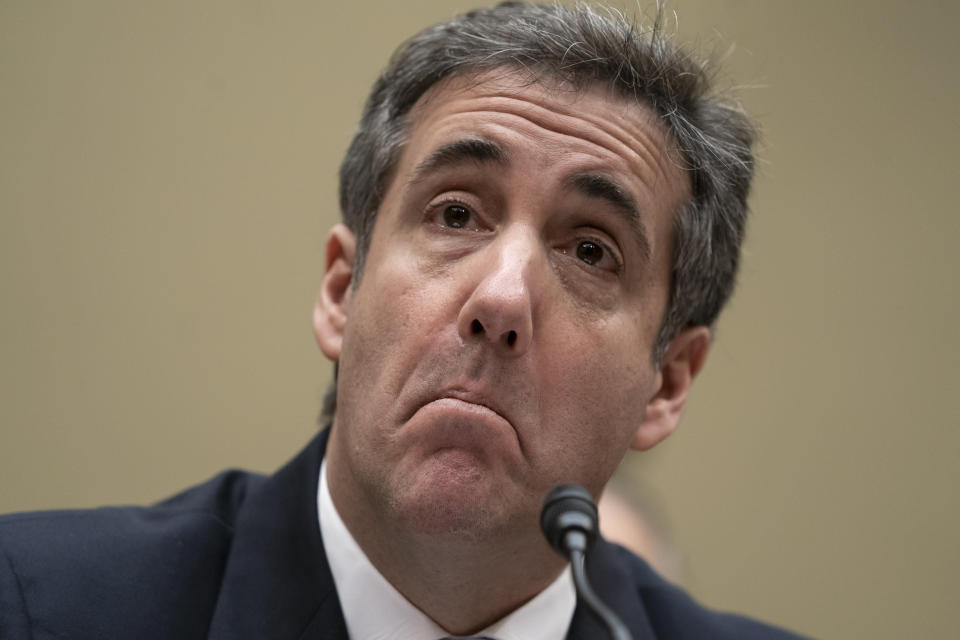 Michael Cohen, President Donald Trump's former personal lawyer, reads an opening statement as he testifies before the House Oversight and Reform Committee on Capitol Hill in Washington, Wednesday, Feb. 27, 2019.  (AP Photo/J. Scott Applewhite)
