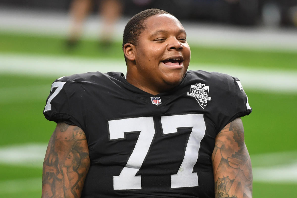 Las Vegas Raiders offensive tackle Trent Brown (77) warms up with a mask on  during a practice …