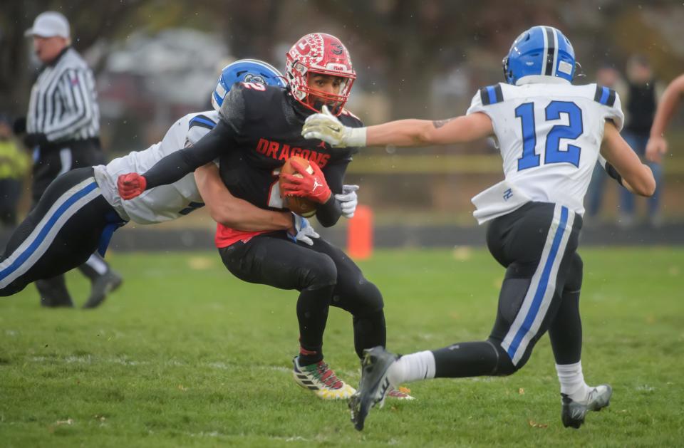 Pekin's Kanye Tyler tries to maneuver around a pair of Lake Zurich defenders during their Class 7A football quarterfinal Saturday, Nov. 12, 2022 in Pekin.