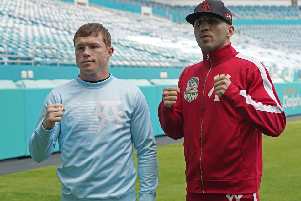 Boxers Saul "Canelo" Alvarez, left, and Avni Yildirim pose for photos at Hard Rock Stadium, Monday, Feb. 22, 2021, in Miami Gardens, Fla. Alvarez will defend his WBC and WBA super-middleweight titles against Yildirim on Saturday. (AP Photo/Marta Lavandier)