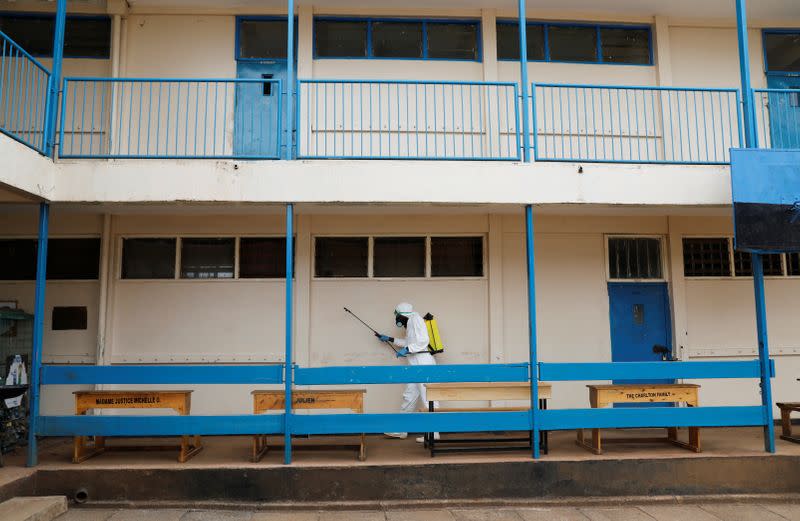 A health worker sprays disinfectants at a school before it is used for mass testing in an effort to stop the spread of the coronavirus disease (COVID-19) in the Kibera slum of Nairobi