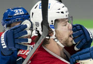 Vancouver Canucks' Travis Hamonic grabs Montreal Canadiens' Josh Anderson by the face during the first period of an NHL hockey game Wednesday, Jan. 20, 2021, in Vancouver, British Columbia. (Jonathan Hayward/The Canadian Press via AP)