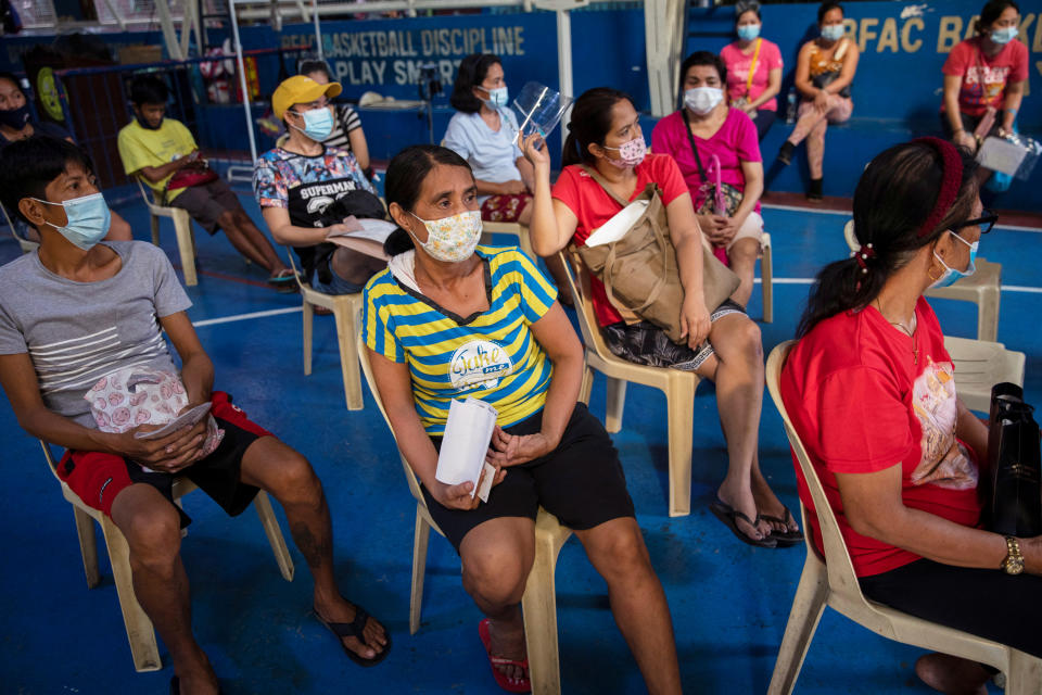 Gemma Roxas, 57, wearing a protective mask for protection against the coronavirus disease (COVID-19), queues for a general check-up at a local health center in Manila, Philippines January 26, 2021. Picture taken January 26, 2021. REUTERS/Eloisa Lopez