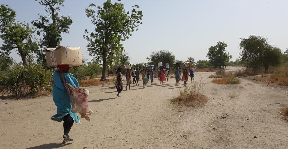 Mobile health workers in South Sudan sometimes have to walk for long hours, so they hire people from the local community to help them haul&nbsp;the supplies they can't carry on their backs. (Photo: Nicolas Peissel/MSF)