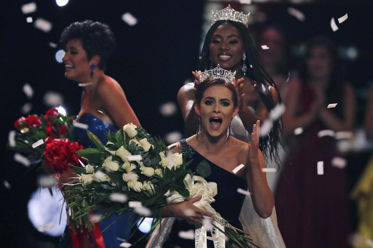 Camille Schrier of Virginia was crowned Miss America 2020 at the Mohegan Sun casino in Uncasville, Conn., on Thursday. At left is runner-up Miss Georgia Victoria Hill, and behind Schrier is Miss America 2019 Nia Franklin. (Photo: AP Photo/Charles Krupa)