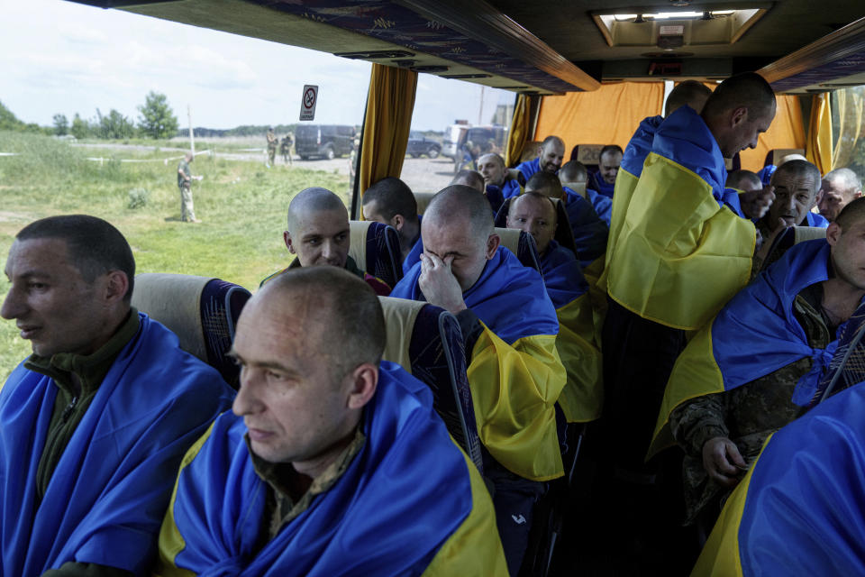 Ukrainian servicemen sit in a bus after returning from captivity during POWs exchange in Sumy region, Ukraine, Friday, May 31, 2024. Ukraine returned 75 prisoners, including four civilians, in the latest exchange of POWs with Russia. It's the fourth prisoner swap this year, and 52nd since Russia invaded Ukraine. In all, 3 210 Ukrainian servicemen and civilians were returned since the outbreak of the war. (AP Photo/Evgeniy Maloletka)