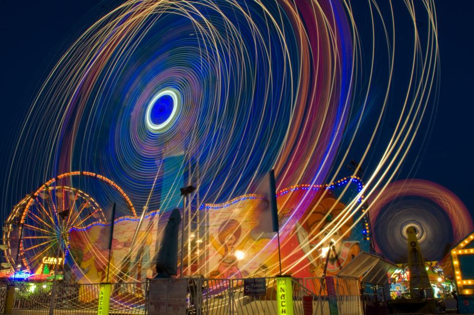 The 1,000 Nights ride is a blur at night on the carnival midway at the San Joaquin County Fair in Stockton. Shot with an exposure of 10 seconds.