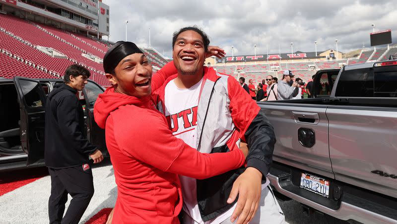 Utah Utes scholarship football players Micah Bernard, left, and Johnny Maea celebrate getting a Dodge truck given to them by the Crimson Collective during an NIL announcement at Rice-Eccles Stadium in Salt Lake City on Wednesday, Oct. 4, 2023.