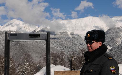 This file photo shows a police officer standing near a metal detector frame at the Gornaya Karusel (Mountain Carousel) sports and holiday complex, that will be used at the 2014 Winter Olympics, in Sochi, on February 11, 2011