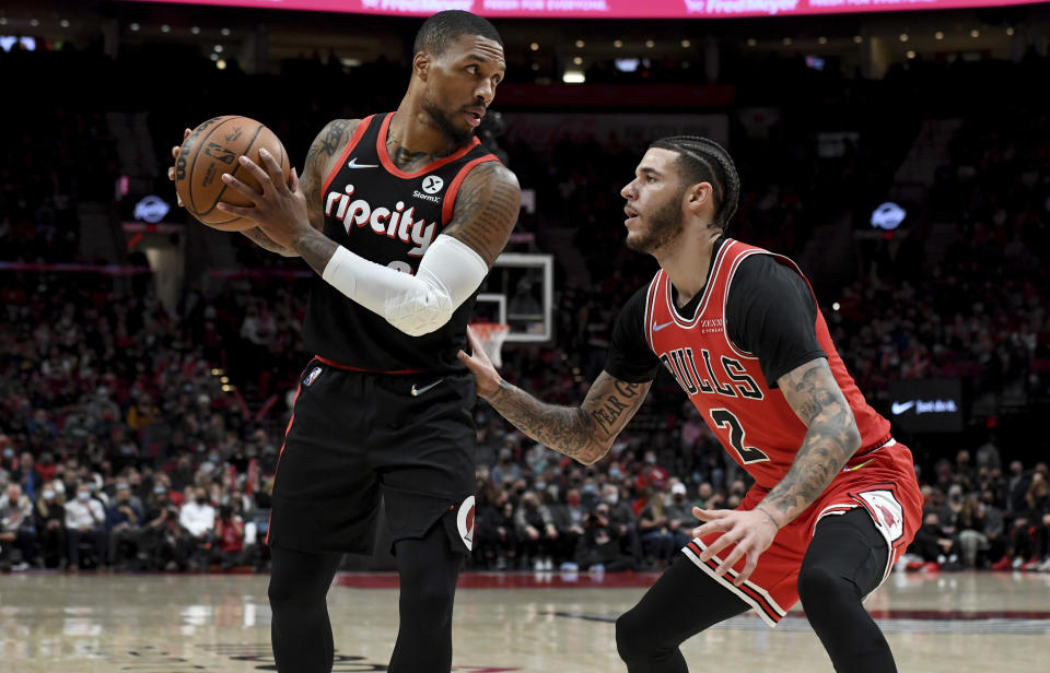 Portland Trail Blazers guard Damian Lillard, left, looks to drive to the basket past Chicago Bulls guard Lonzo Ball during the first half of an NBA basketball game in Portland, Ore., Wednesday, Nov. 17, 2021. (AP Photo/Steve Dykes)