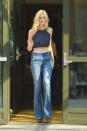 <p>Fanning was on-trend in a complete ‘70s look—from her tousled blonde locks, to the navy blue crop top, to the bell bottom jeans and platform clogs hiding underneath. </p>