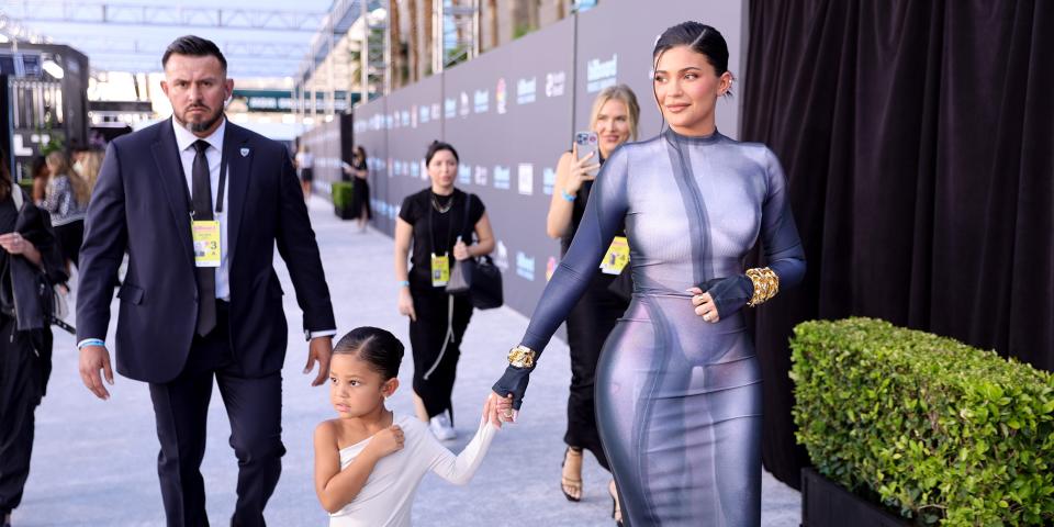 Kylie Jenner holding hands with her daughter Stormi Webster.