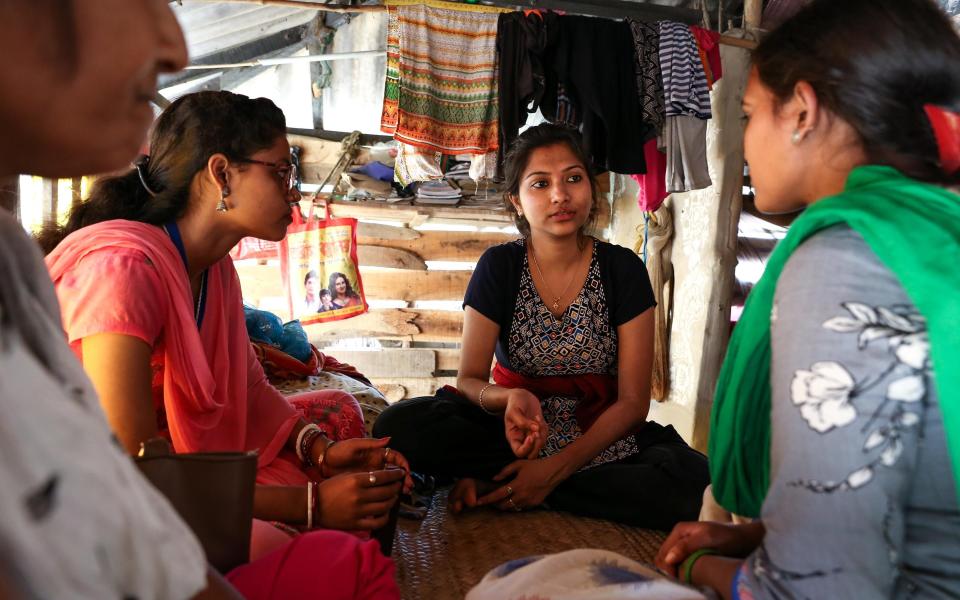 Subhasree Raptan (centre), programme manager of GGBK, speaks to a trafficking survivor in her home in Goran Bose, West Bengal - Catherine Davison