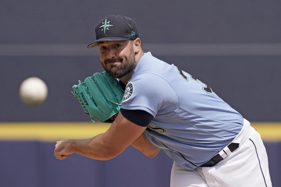 Seattle Mariners starting pitcher Robbie Ray throws during the first inning of a spring training baseball game against the Texas Rangers Monday, March 28, 2022, in Peoria, Ariz. (AP Photo/Charlie Riedel)