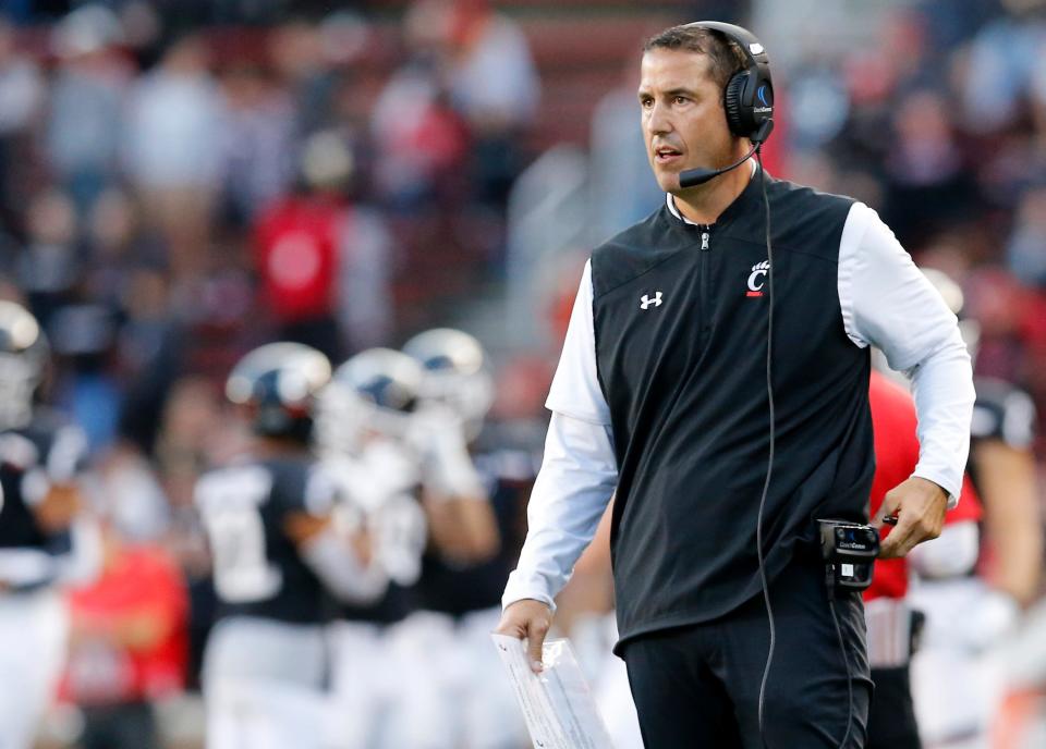 Cincinnati Bearcats head coach Luke Fickell brings his team to the sideline during a timeout in the fourth quarter of the NCAA American Athletic Conference game between the Cincinnati Bearcats and the Tulsa Golden Hurricane at Nippert Stadium in Cincinnati on Saturday, Oct. 19, 2019. The Bearcats became bowl eligible , improving to 6-1, with a 24-13 win at home.