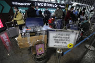 Passengers arriving from China arrive at a COVID-19 testing center at the Incheon International Airport in Incheon, South Korea on Jan. 14, 2023. A hoped-for boom in Chinese tourism in Asia over next week’s Lunar New Year holidays looks set to be more of a blip as most travelers opt to stay inside China if they go anywhere. (AP Photo/Ahn Young-joon)