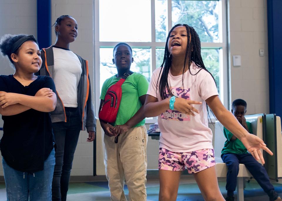 Fourth-grader Jazzlyn Jackson, right, leads a chant Wednesday during the Central Gulf Coast Children's Defense Fund Freedom School's morning Harambee —which means "all pull together" in Swahili — at the Global Learning Academy in Pensacola.