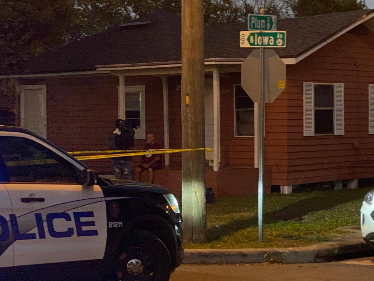 Police cruisers block Iowa Avenue at Plum Street early Monday evening at the scene of a drive-by shooting that wounded 10 people, two critically.