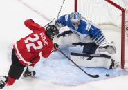 Canada's Dylan Cozens (22) is stopped by Finland goalie Kari Piiroinen (1) during the third period of an IIHF World Junior Hockey Championship game Thursday, Dec. 31, 2020, in Edmonton, Alberta. (Jason Franson/The Canadian Press via AP)