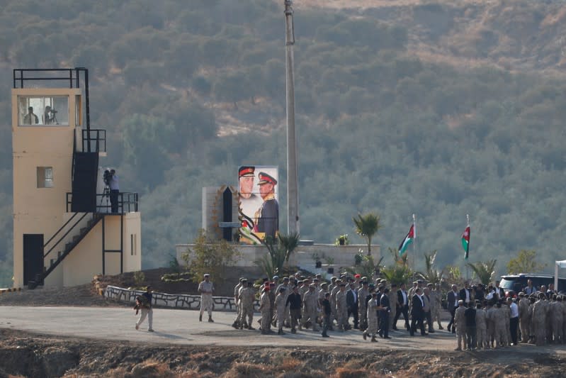 Jordan's King Abdullah and a delegation take part in a ceremony in an area known as Naharayim in Hebrew and Baquora in Arabic, in the border area between Israel and Jordan, as seen from the Israeli side