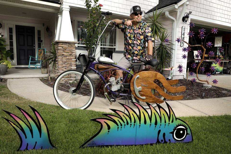 Scotie Cousin tends to attract some attention at his Atlantic Beach home with his custom-engineered and decorated bike and some of his artistic creations.
