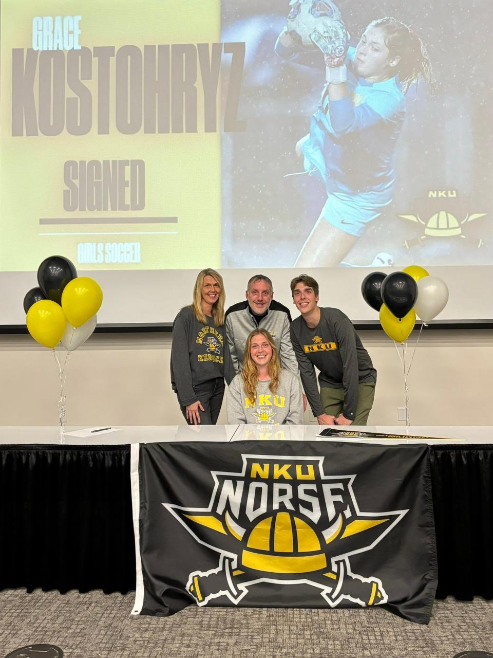 Wooster senior and standout goalkeeper, the heartbeat and MVP of her team, Grace Kostohryz relaxes after signing her letter of intent to Northern Kentucky University with her family.
