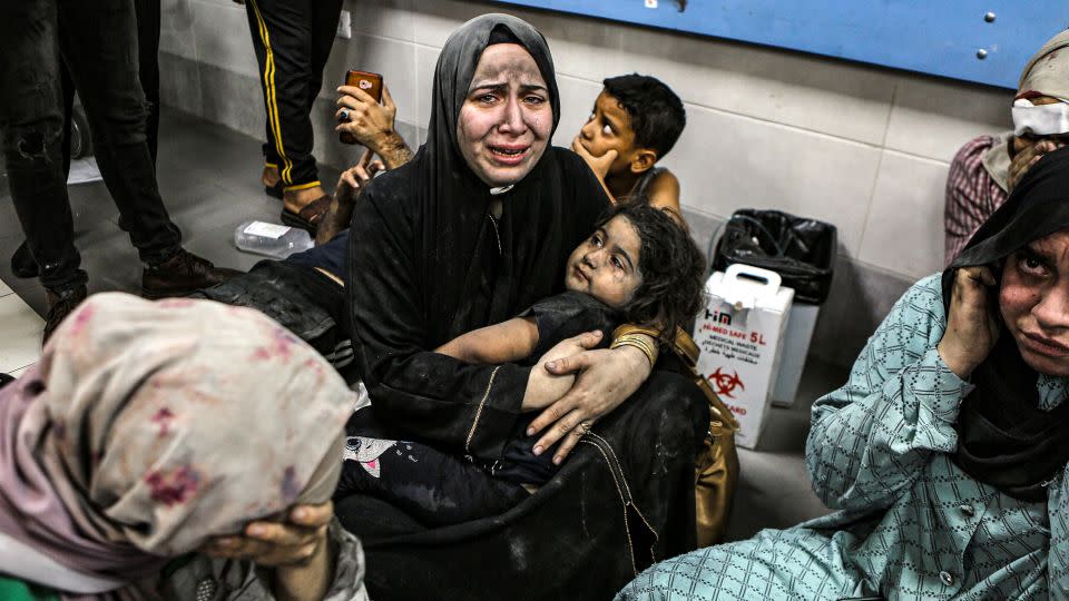 Wounded Palestinians sit in al-Shifa hospital in Gaza City on Oct. 17, 2023. - Abed Khaled/AP