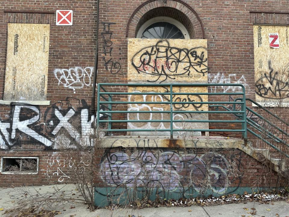 Graffiti is seen on a vacant building in downtown Burlington, Vt., on Dec. 6, 2023. Some residents of the city of 45,000 have raised concerns about public drug and alcohol use, discarded needles, graffiti-covered buildings and violence in the city. (AP Photo/Lisa Rathke)