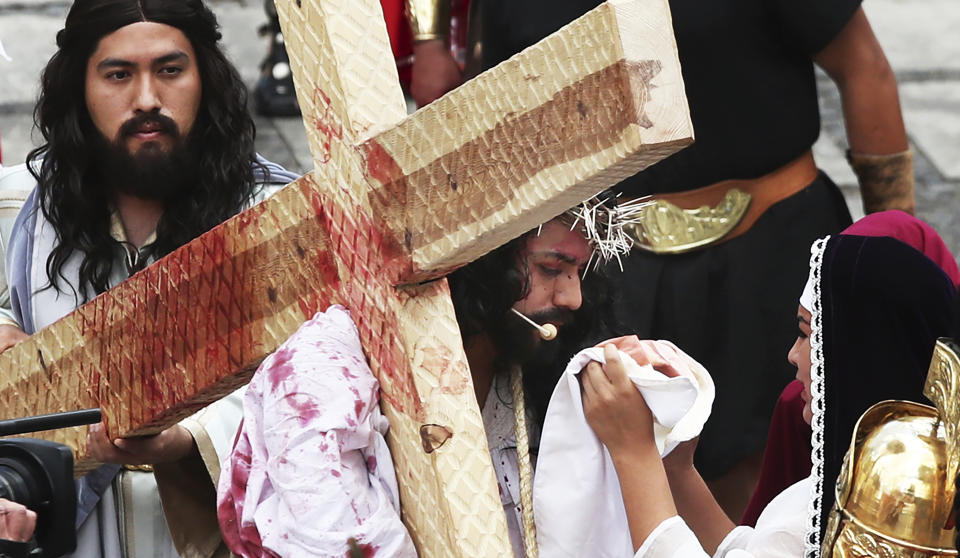 Residents reenact the crucifixion of Jesus Christ in the Passion Play of Iztapalapa, outside the Cathedral, on the outskirts of Mexico City, Friday, April 2, 2021, amid the new coronavirus pandemic. To help prevent the spread of the COVID-19, Latin America's most famous re-enactment of the crucifixion of Christ was closed to the public and transmitted live so people could watch at home, for a second consecutive year. (AP Photo/Marco Ugarte)