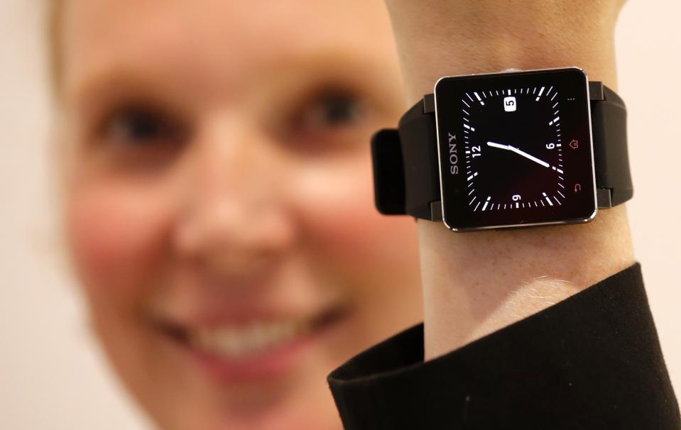 A model poses with a Sony SmartWatch 2 at the Sony booth during a media preview day at the IFA consumer electronics fair in Berlin, September 5, 2013. The IFA consumer electronics and home appliances fair will open its doors to the public from September 6 till 11 in the German capital. REUTERS/Fabrizio Bensch (GERMANY - Tags: SCIENCE TECHNOLOGY BUSINESS)