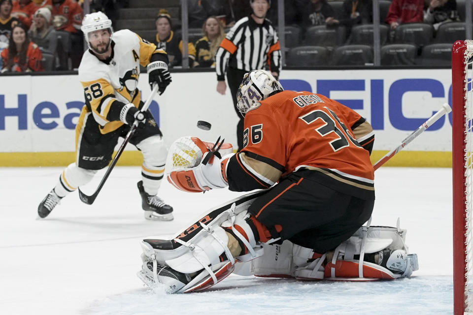 Anaheim Ducks goaltender John Gibson blocks a shot by Pittsburgh Penguins defenseman Kris Letang during the first period of an NHL hockey game in Anaheim, Calif., Friday, Feb. 28, 2020. (AP Photo/Chris Carlson)