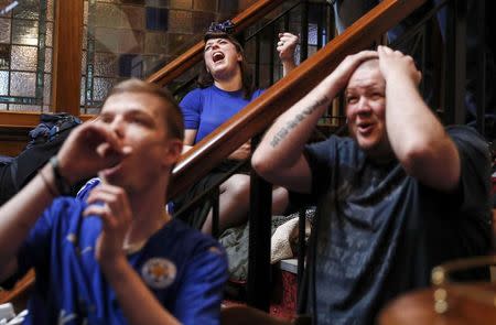 Leicester City fans react during their team's soccer match against Manchester United, as they watch the match on television in the Hogarth's pub in Leicester, Britain May 1, 2016. REUTERS/Eddie Keogh