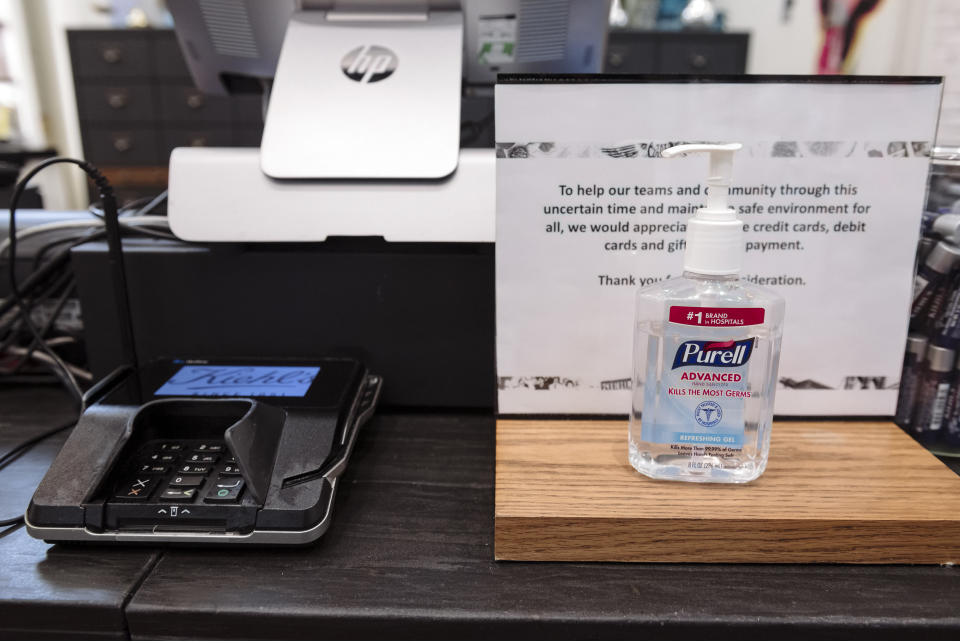 A bottle of hand sanitizer sits next to a credit card machine at a Kiehl's store at Westfield San Francisco Centre in San Francisco, California, U.S., on Thursday, June 18, 2020. (Michael Short/Bloomberg via Getty Images)