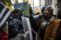 Back the Blue police supporters, left, stand next to Black Lives Matter protesters calling for defunding the police, Thursday, Nov. 5, 2020, in Portland, Ore. (AP Photo/Paula Bronstein)