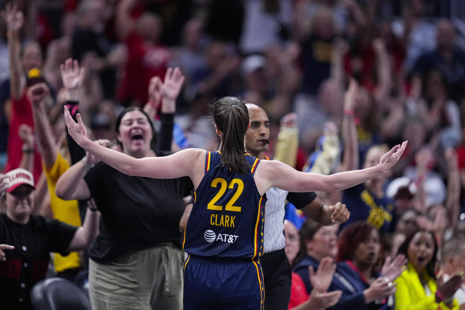 Indiana Fever guard Caitlin Clark (22) celebrates after a three-point basket against the Dallas Wings in the first half of a WNBA basketball game in Indianapolis, Sunday, Sept. 15, 2024. (AP Photo/Michael Conroy)