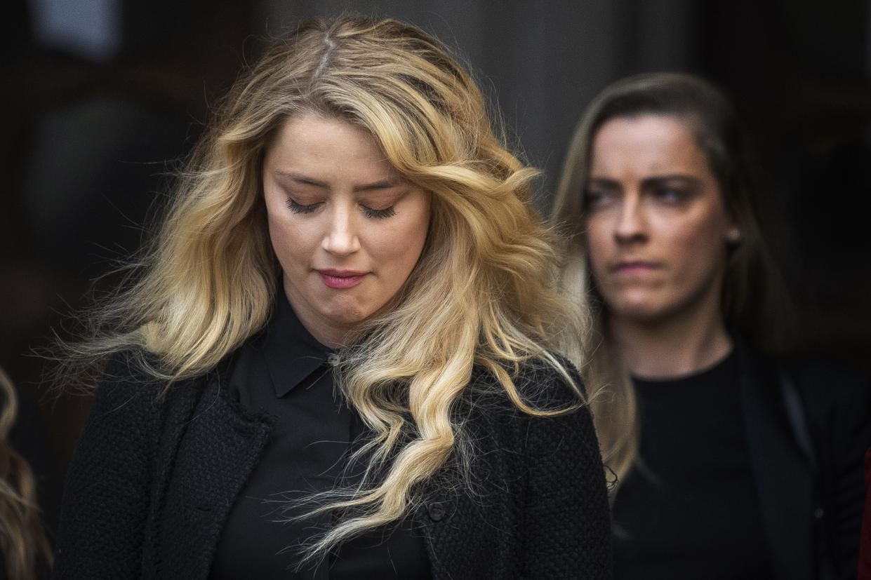 Actress Amber Heard, alongside her sister Whitney Henriquez, as she gives a statement outside the High Court in London on the final day of hearings in Johnny Depp's libel case against the publishers of The Sun and its executive editor, Dan Wootton. After almost three weeks, the biggest English libel trial of the 21st century is drawing to a close, as Mr Depp's lawyers are making closing submissions to Mr Justice Nicol. (Photo by Victoria Jones/PA Images via Getty Images)